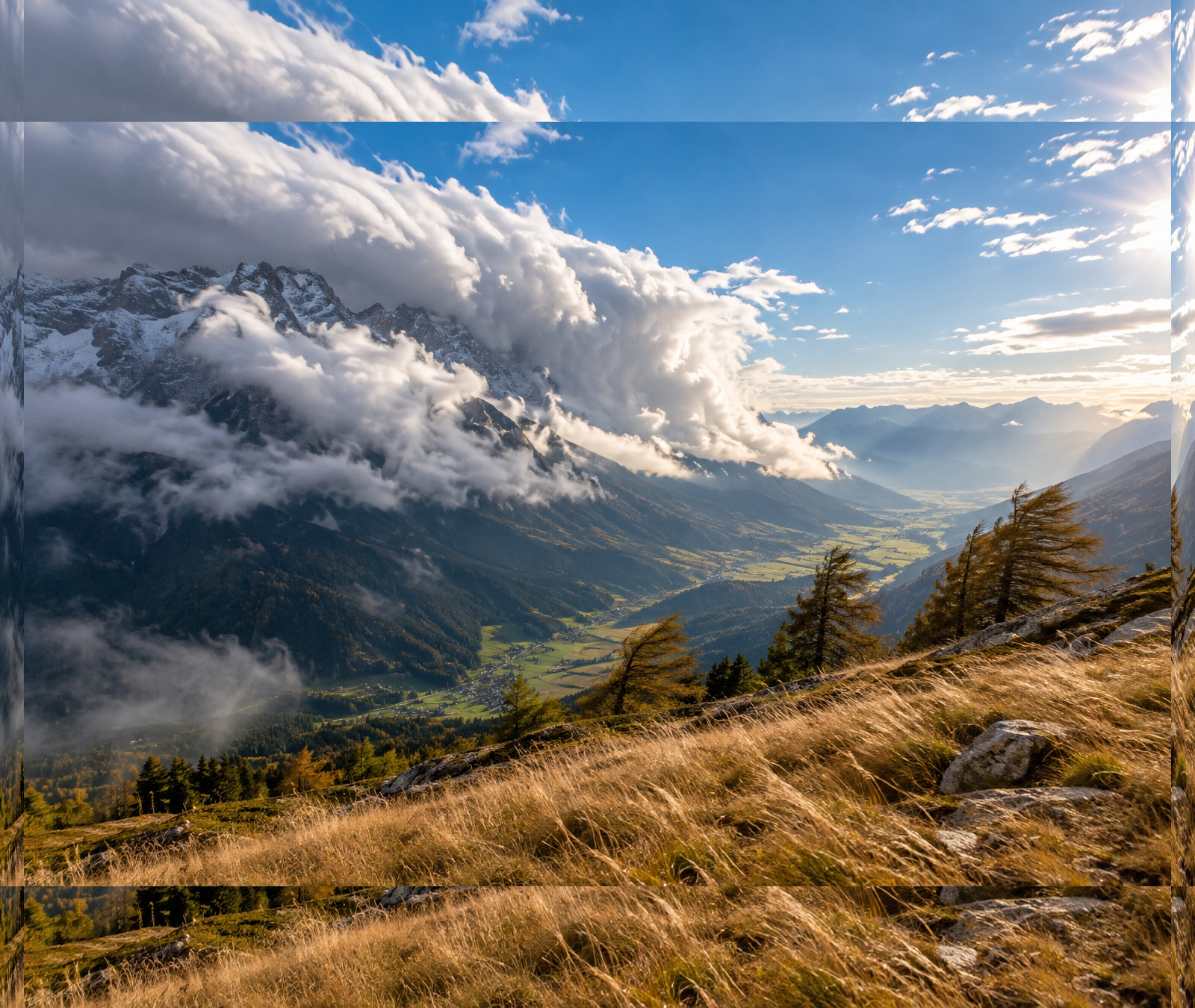 Alpental mit Wolkenstau am Gebirge und sonniger, trockener Leeseite